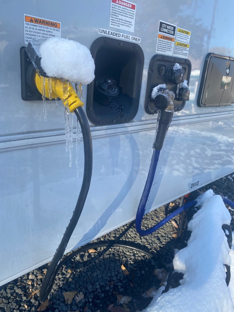 Frozen power cord and water hose on our RV.
