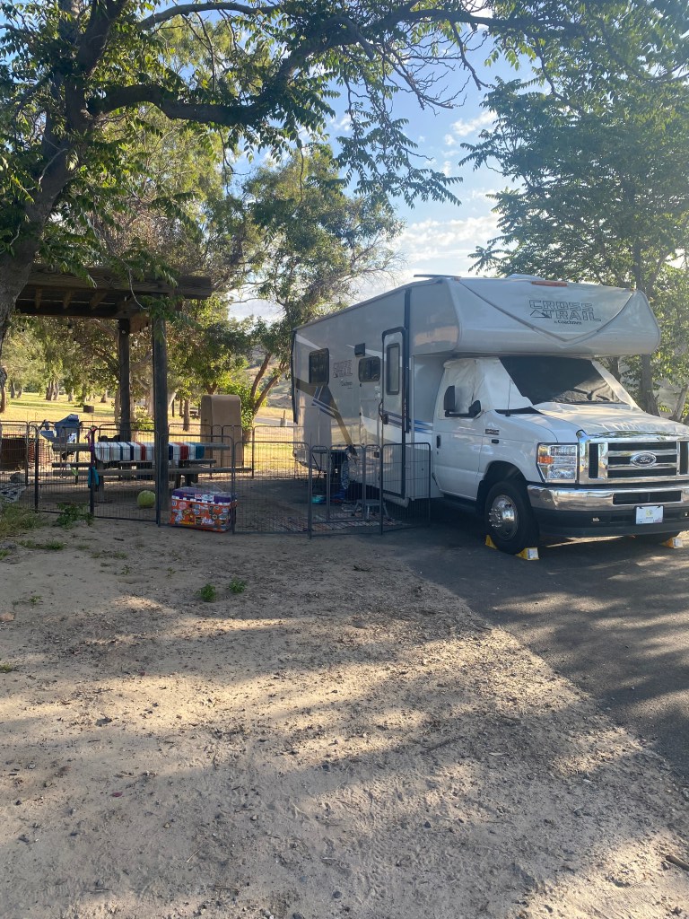 Our RV parked in a campsite - you'll learn that in this RV guide.